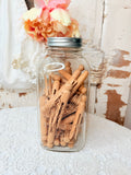 VINTAGE GLASS JAR OF CLOTHESPINS