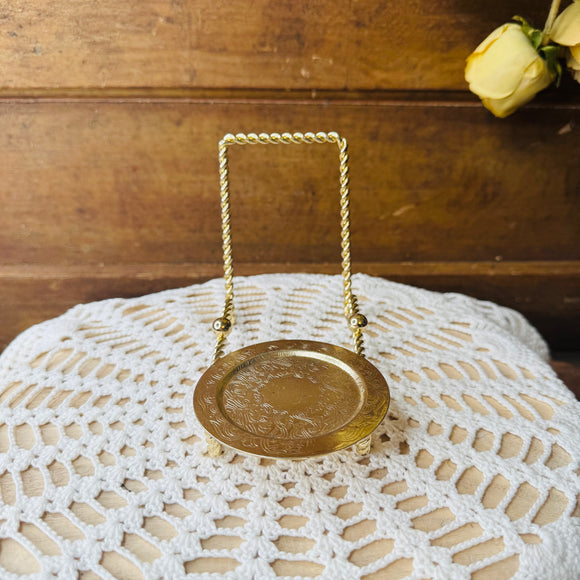 BRASS TEACUP AND SAUCER DISPLAY