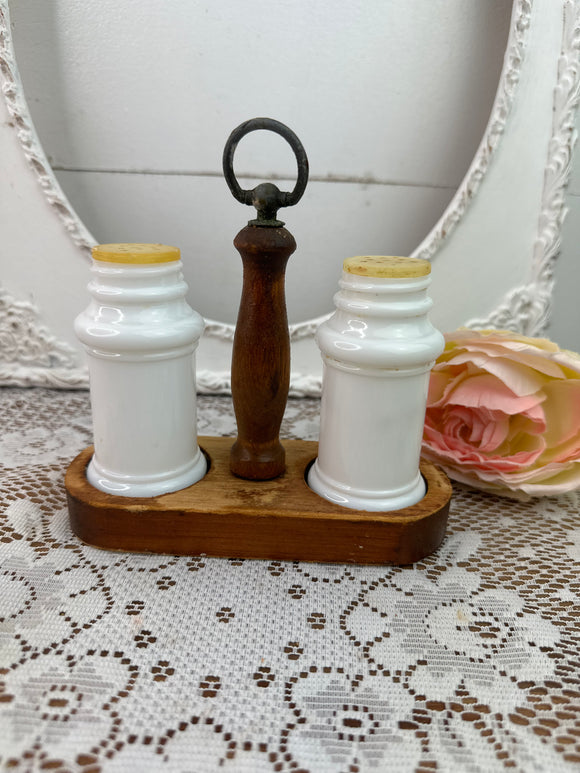 MILK GLASS SALT AND PEPPER SHAKERS IN WOOD HOLDER